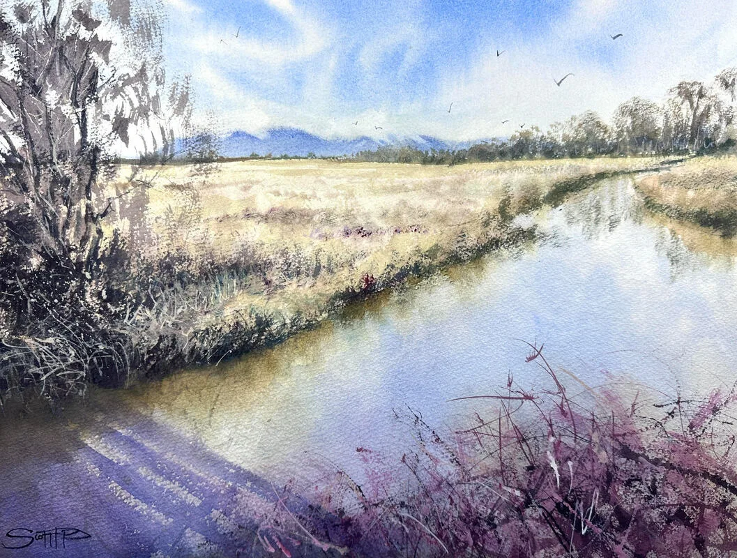 A watercolour painting by Scott Pleydell-Pearce showing the view from Ladner boat basin looking north to the Vancouver mountains. The river is calm and reflects the surrounding grasses and trees and blue sky. In the foreground is a violet refelction of the bridge and a bramble bush of dark reds and pinks.