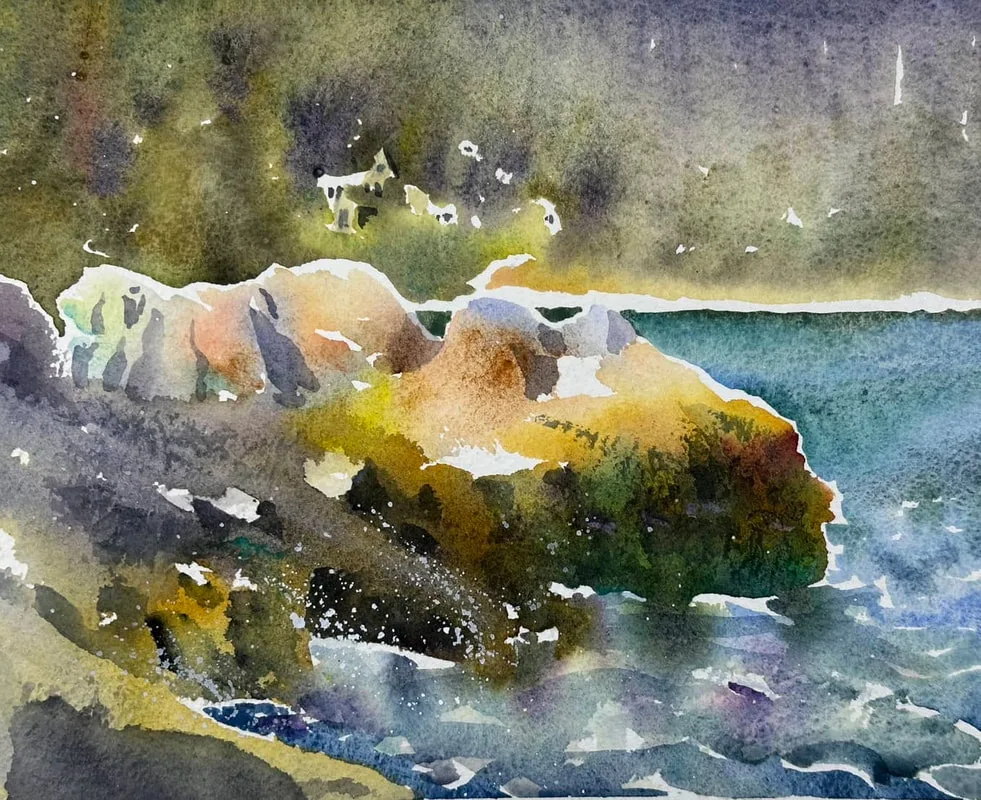 A watercolour painting in an impressionistic style of brightly coloured rocks meeting the ocean with soft distant trees and beach in the background.